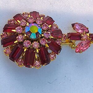 This vintage Juliana flower brooch features a charming design with pink and red